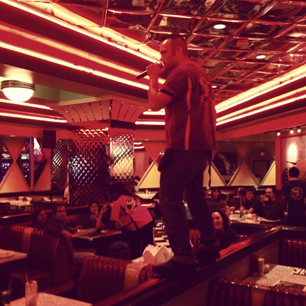 some waiters sing, some bring food,...